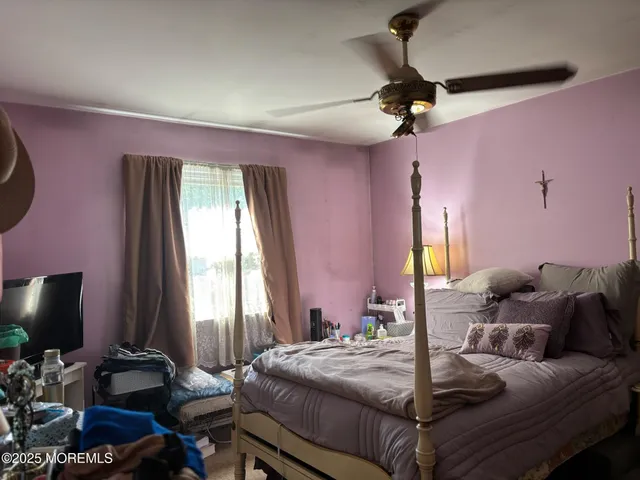 a bed room with a bed window and a flat screen tv