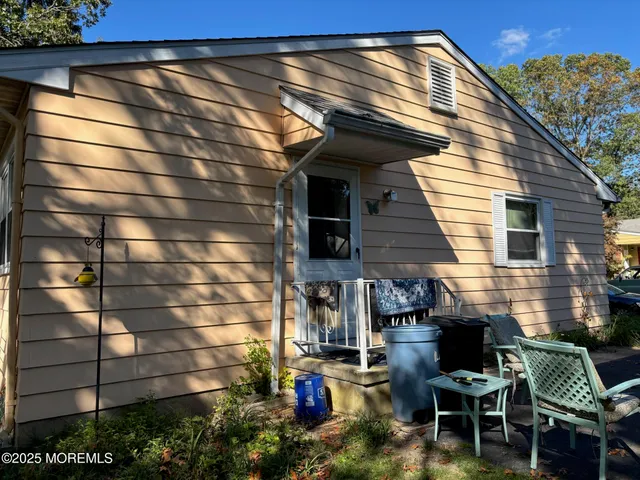 a view of a patio with table and chairs with wooden floor and plants