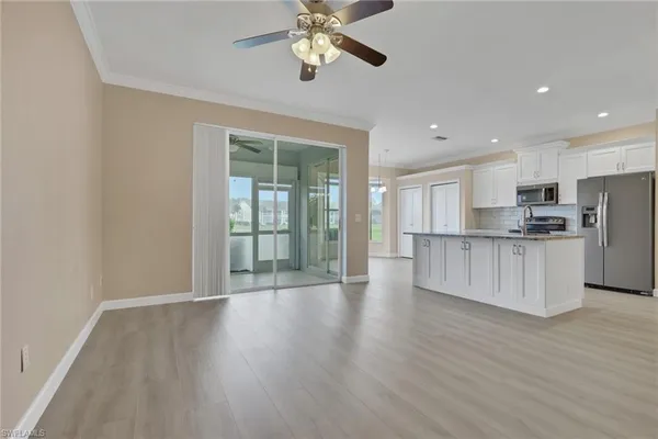 a view of kitchen with refrigerator and wooden floor