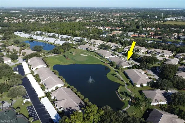 an aerial view of a house with a swimming pool outdoor seating and yard