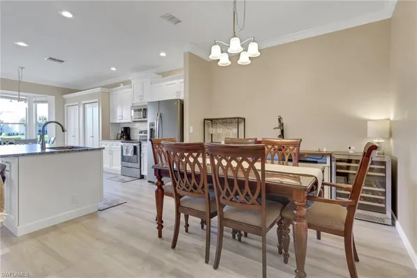 a view of a dining room with furniture and chandelier