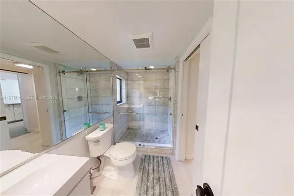 a bathroom with a double vanity sink a mirror and shower