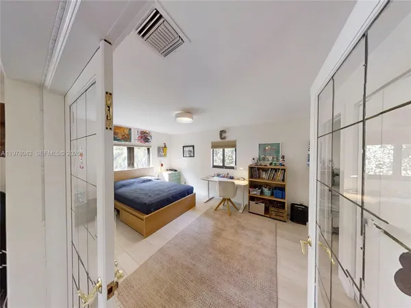 a bed room with a bed window and a couch
