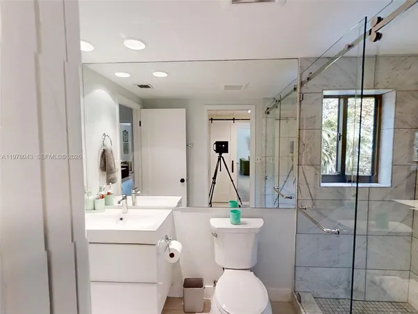 a bathroom with a sink a toilet and mirror