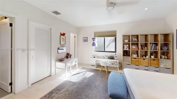 a bedroom with a large bed and a couch
