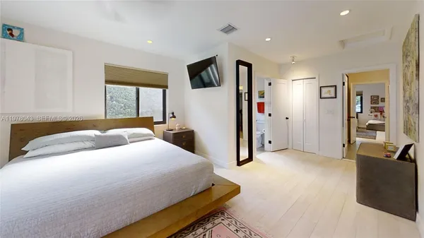 a bedroom with a bed and a cabinets