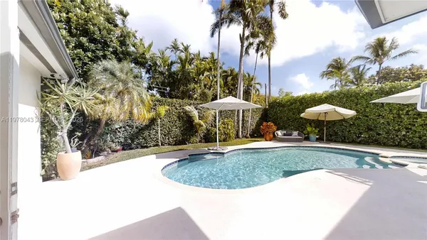 a swimming pool with outdoor seating yard and barbeque oven