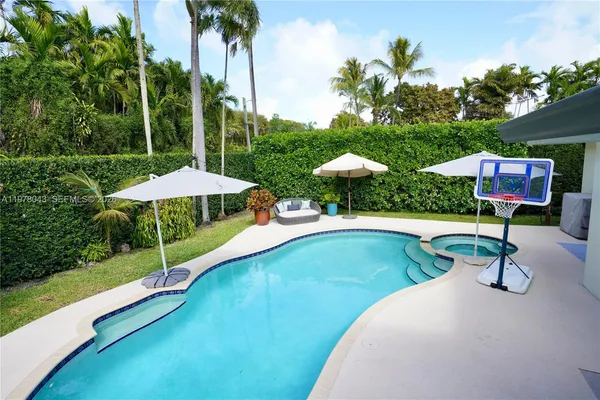 a view of a swimming pool and lounge chair