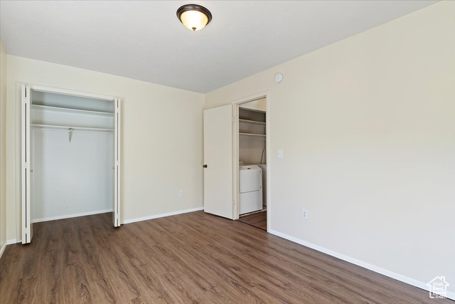 947 Canyon Road South, Unit 15 Ogden, UT 84404 - Photo 16 of 22 Unfurnished bedroom with a closet, dark wood-type flooring, and washer / clothes dryer