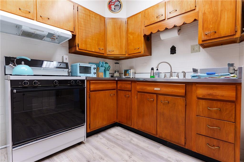 17 Bailey Avenue Pittsburgh, PA 15211 - Photo 11 of 22 a kitchen with stainless steel appliances granite countertop a sink a stove and cabinets
