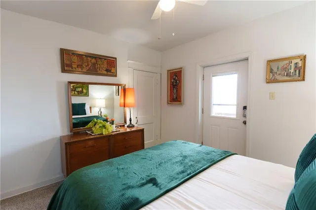 a bedroom with a bed and a large window