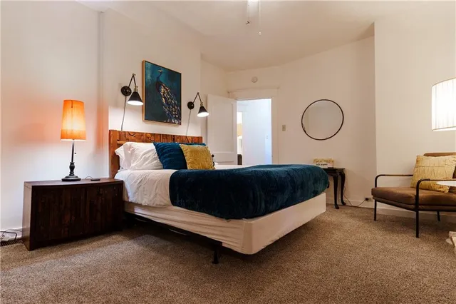 a bedroom with a large bed and a chandelier