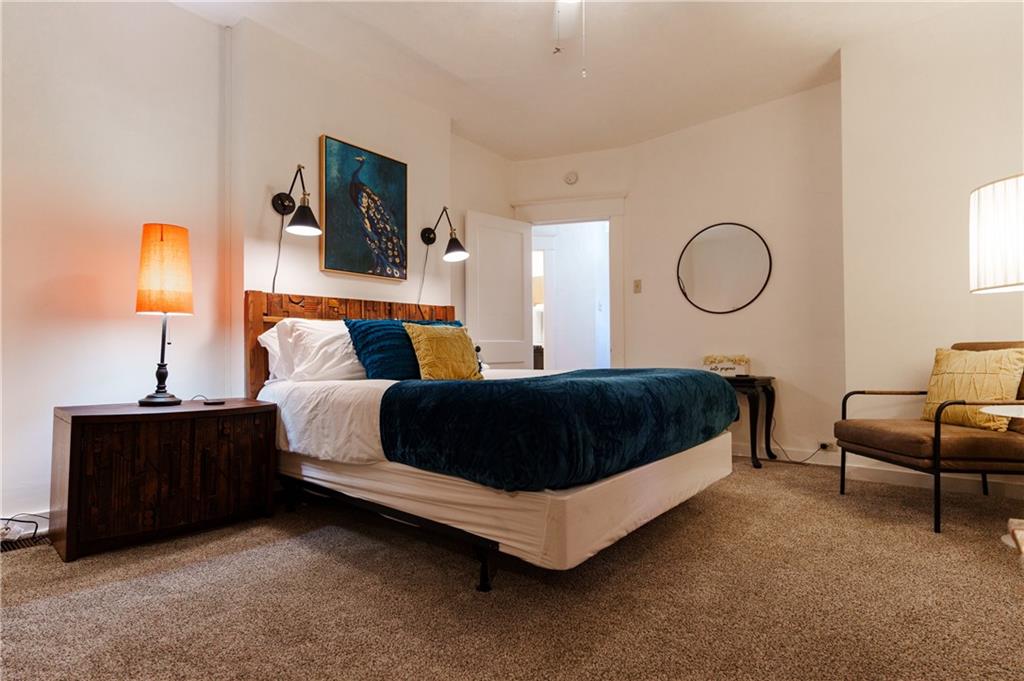 17 Bailey Avenue Pittsburgh, PA 15211 - Photo 19 of 22 a bedroom with a bed a lamp and a flat screen tv