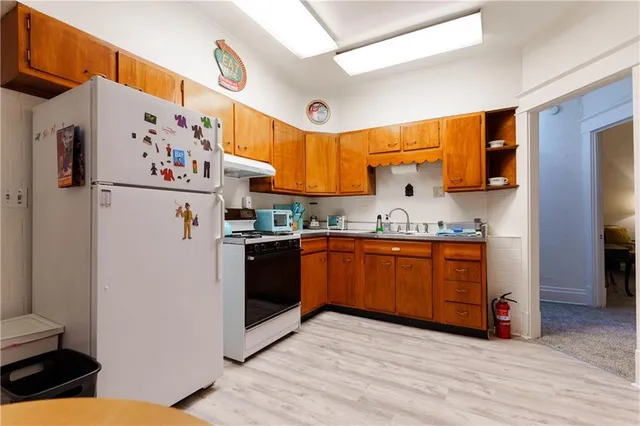 a kitchen with stainless steel appliances granite countertop a sink a stove and cabinets