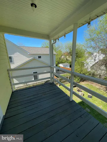 a view of a balcony with yard