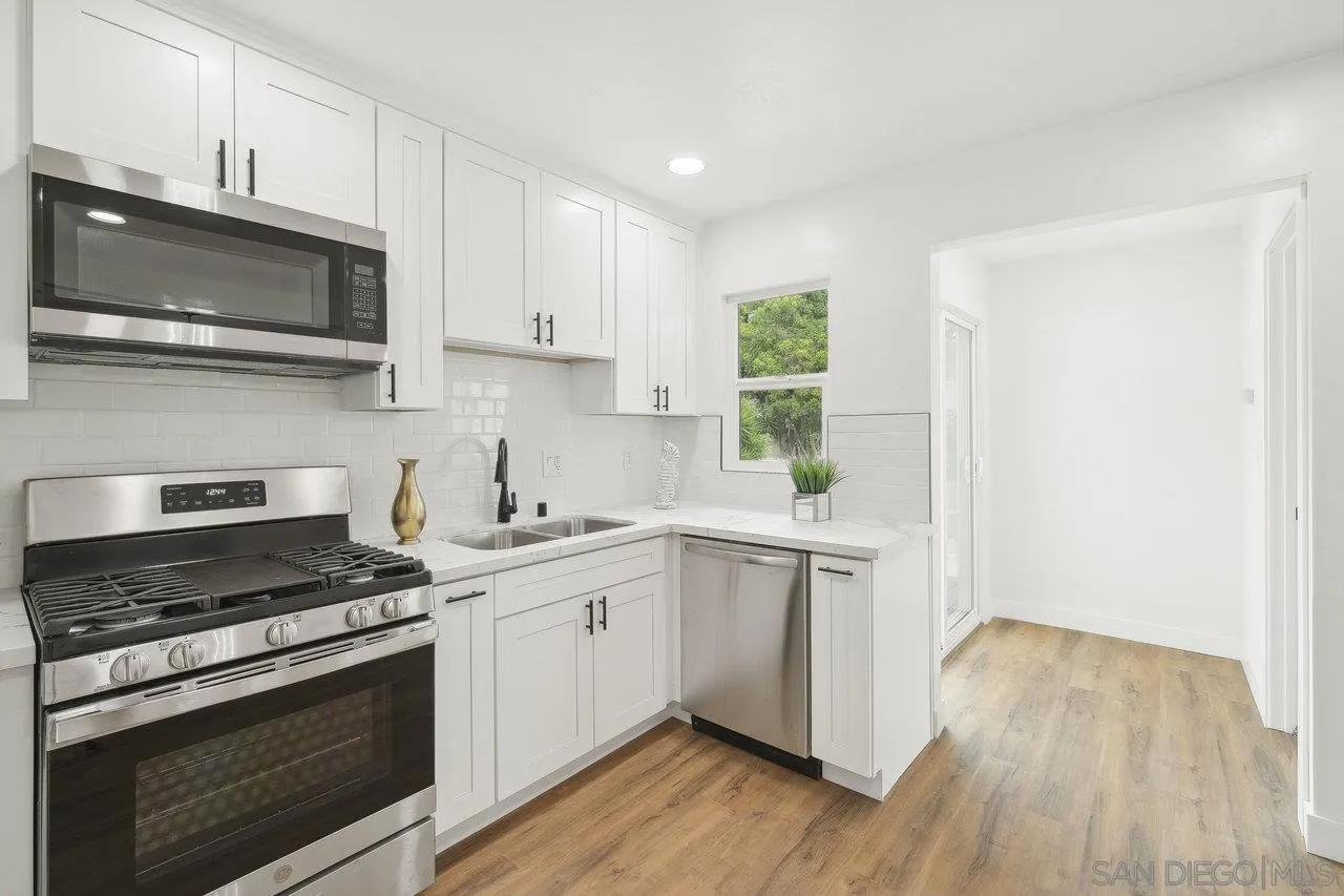 4741 Maple Avenue La Mesa, CA 91942 - Photo 13 of 34 a kitchen with stainless steel appliances white cabinets and a stove top oven