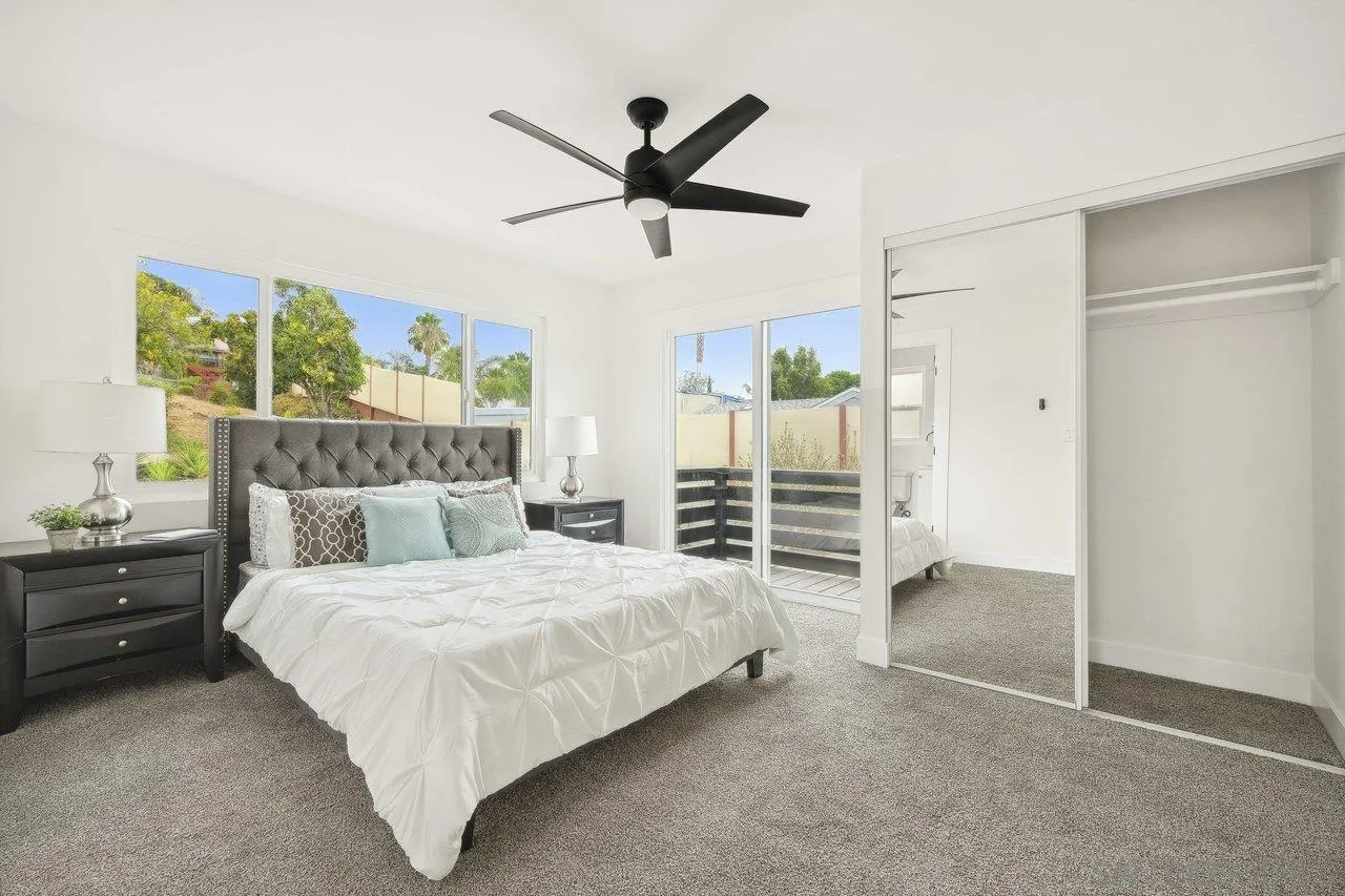 4741 Maple Avenue La Mesa, CA 91942 - Photo 16 of 34 a bedroom with a bed and a ceiling fan