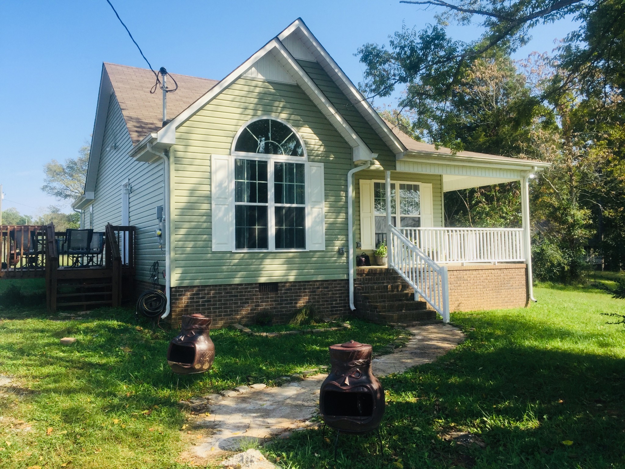 63 Robertson Hollow Road Taft, TN 38488 - Photo 1 of 16 a front view of a house with garden