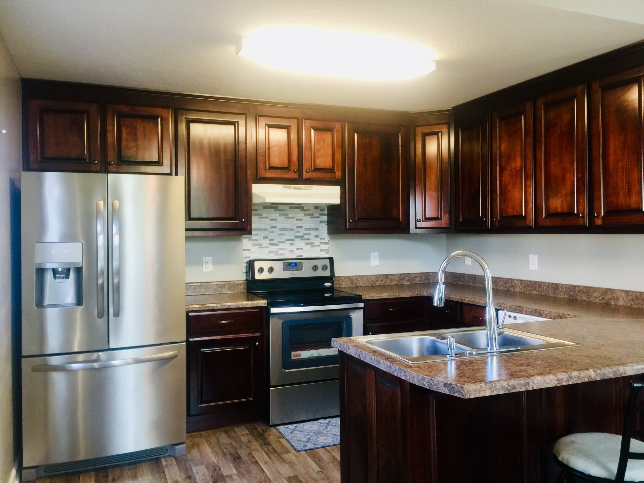 63 Robertson Hollow Road Taft, TN 38488 - Photo 3 of 16 a kitchen with stainless steel appliances granite countertop a refrigerator a sink and a stove