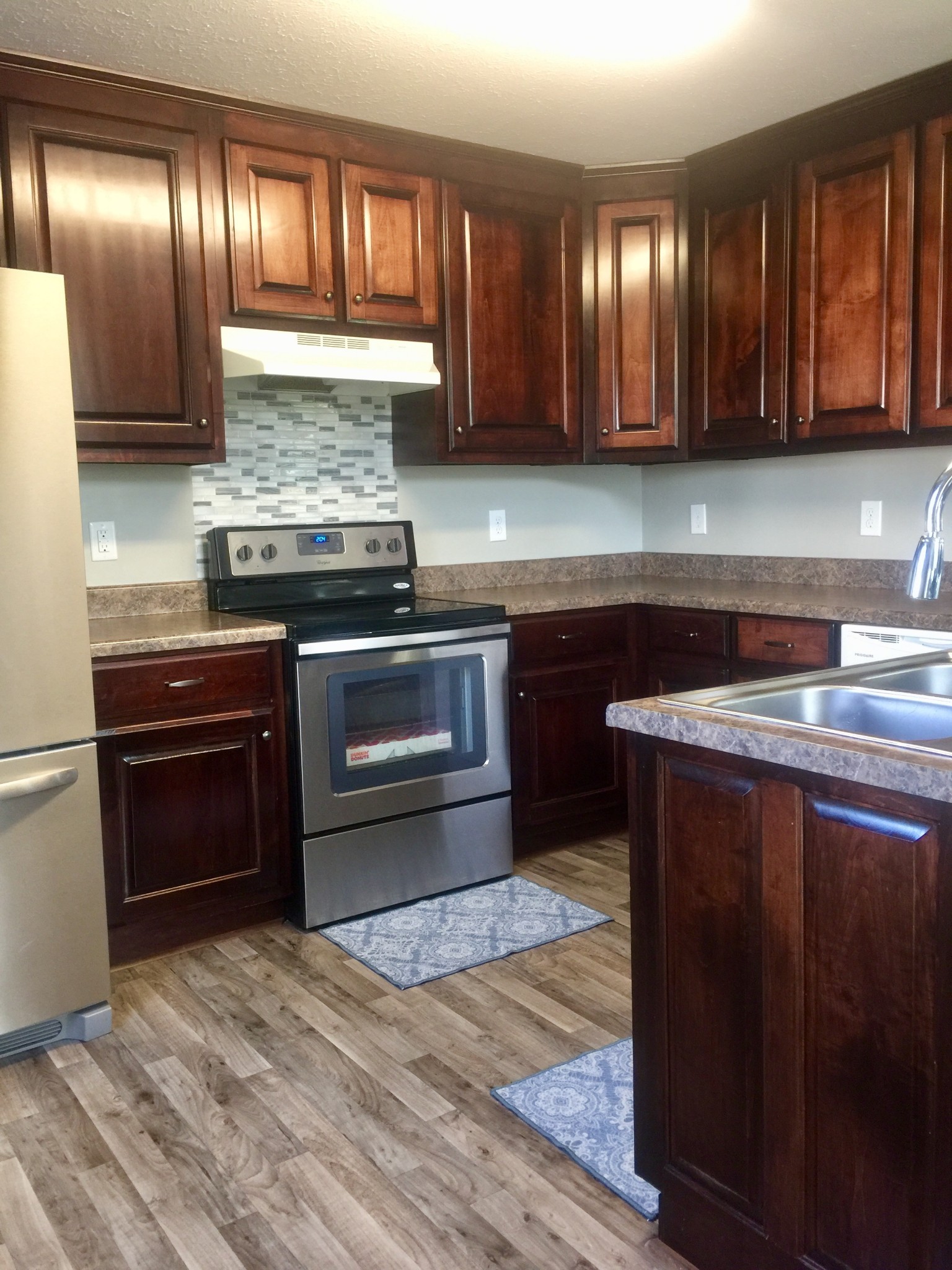 63 Robertson Hollow Road Taft, TN 38488 - Photo 4 of 16 a kitchen with granite countertop wood cabinets and stainless steel appliances