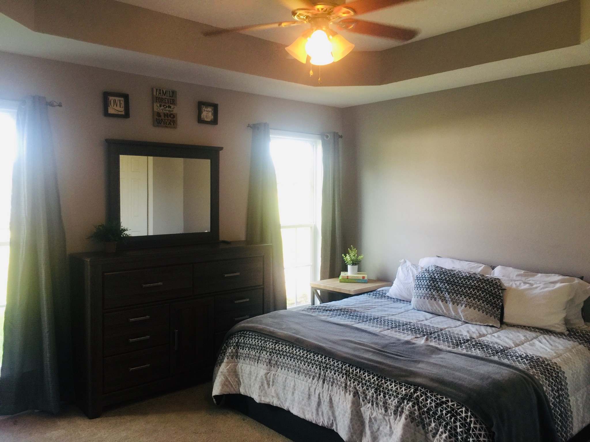 63 Robertson Hollow Road Taft, TN 38488 - Photo 8 of 16 a bedroom with a bed and a mirror on dresser