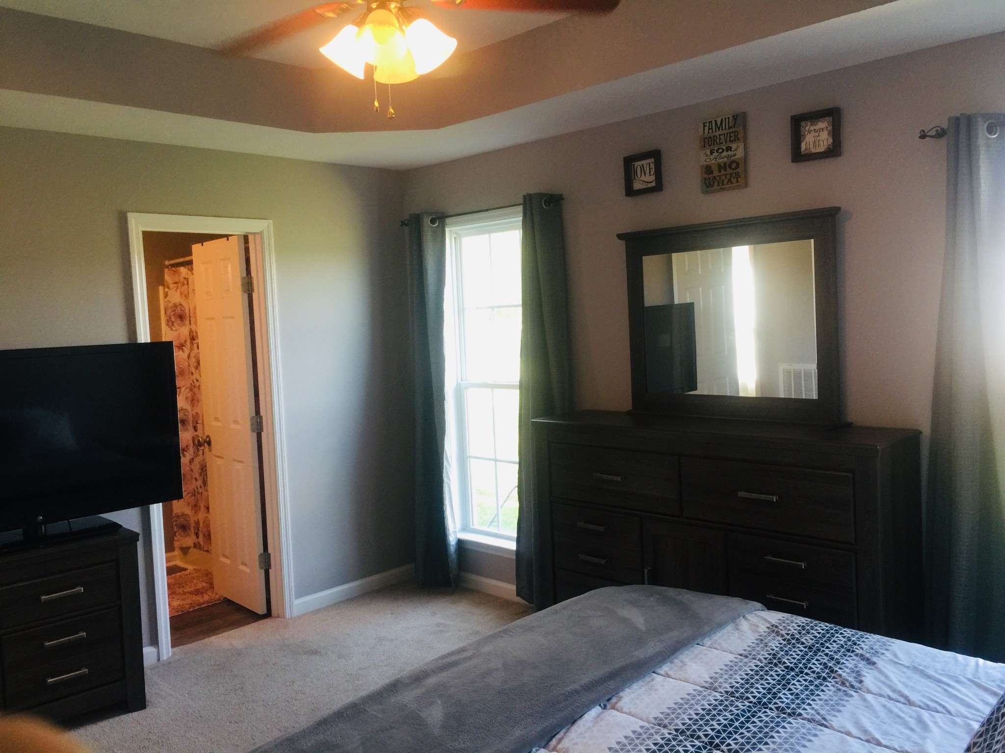 63 Robertson Hollow Road Taft, TN 38488 - Photo 9 of 16 a bedroom with a bed and a flat tv screen on dresser