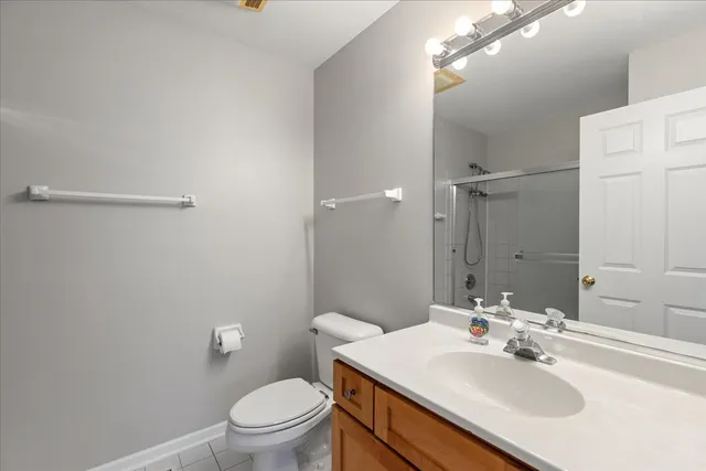 a bathroom with a sink toilet and a mirror