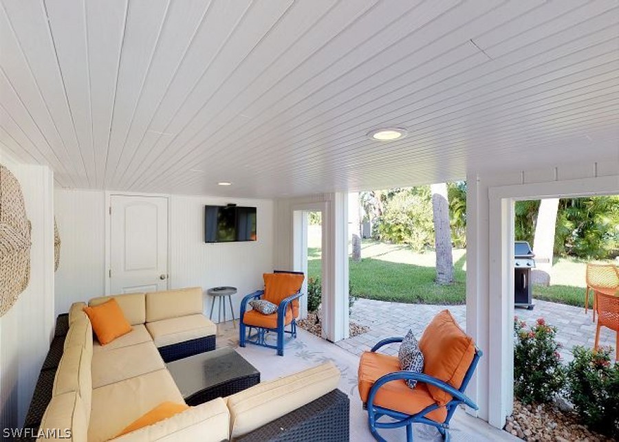 151 Mandalay Road Fort Myers Beach, FL 33931 - Photo 12 of 32 a outdoor living space with furniture and garden