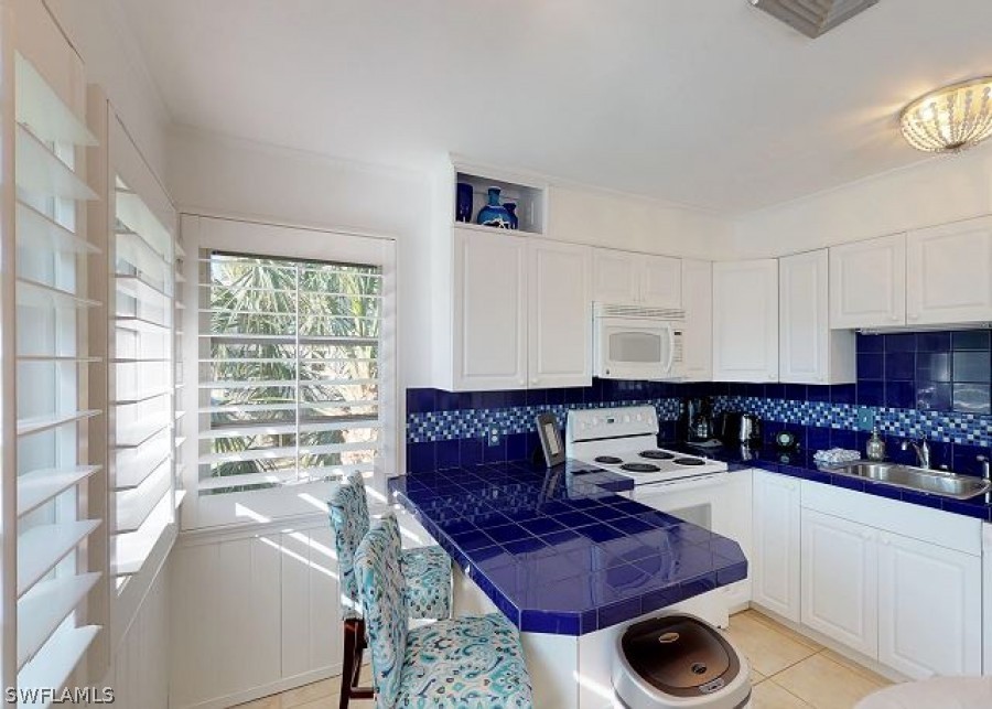151 Mandalay Road Fort Myers Beach, FL 33931 - Photo 17 of 32 a living room with furniture and a rug