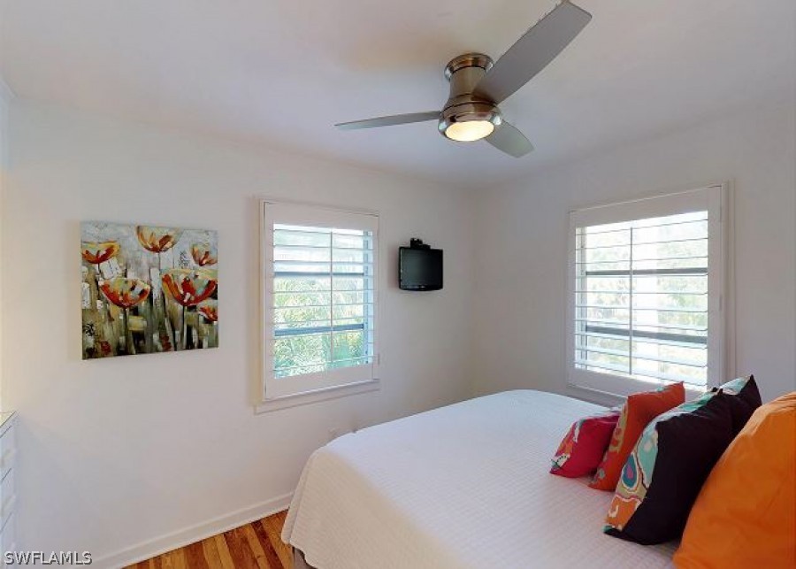 151 Mandalay Road Fort Myers Beach, FL 33931 - Photo 20 of 32 a bedroom with a bed and a window