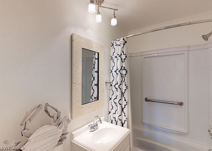 151 Mandalay Road Fort Myers Beach, FL 33931 - Photo 23 of 32 a bathroom with a sink toilet and shower