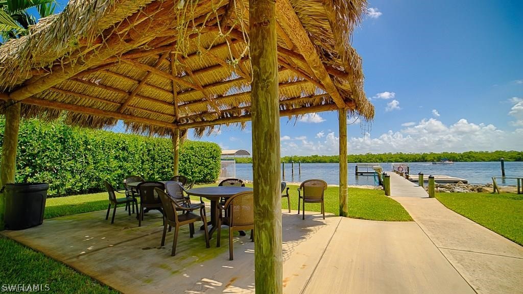 151 Mandalay Road Fort Myers Beach, FL 33931 - Photo 27 of 32 a view of a patio with a table chairs and a patio