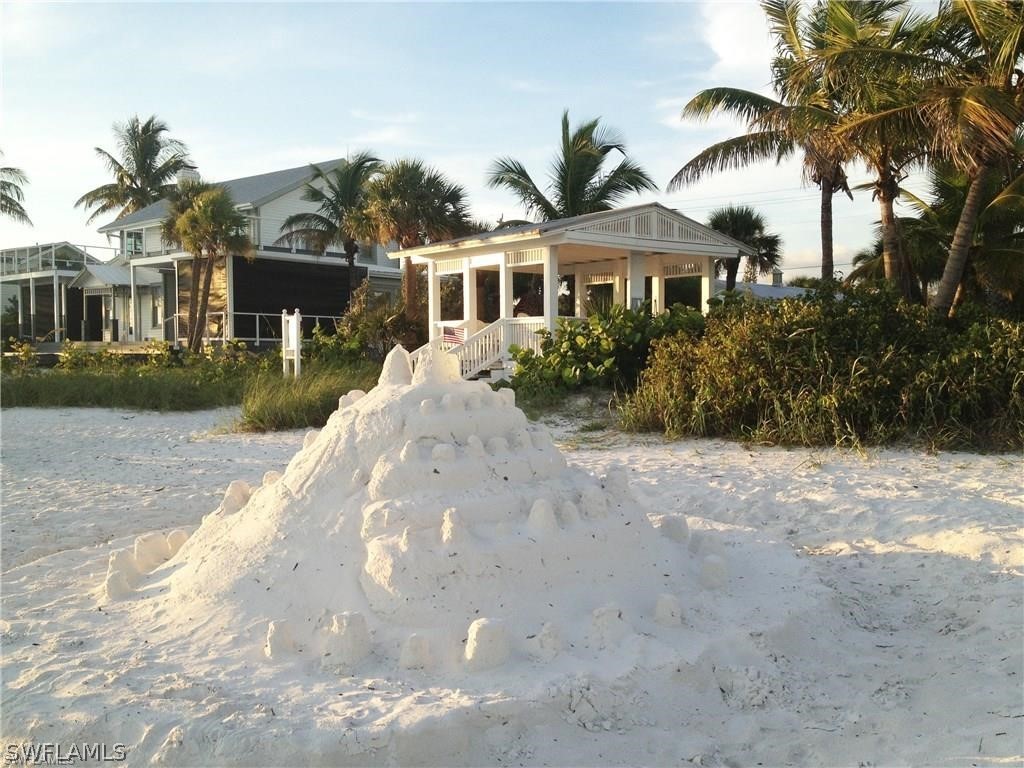 151 Mandalay Road Fort Myers Beach, FL 33931 - Photo 28 of 32 a front view of a house with a garden