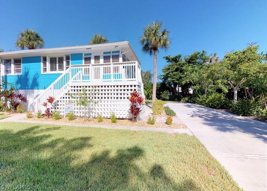 151 Mandalay Road Fort Myers Beach, FL 33931 - Photo 3 of 32 a front view of a house with a yard