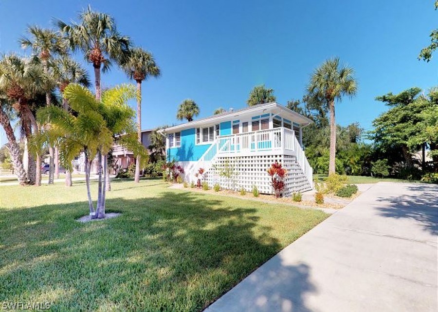 151 Mandalay Road Fort Myers Beach, FL 33931 - Photo 5 of 32 a view of a house with a yard