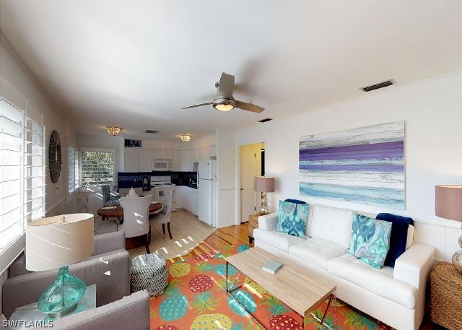 151 Mandalay Road Fort Myers Beach, FL 33931 - Photo 6 of 32 a living room with furniture and a large window
