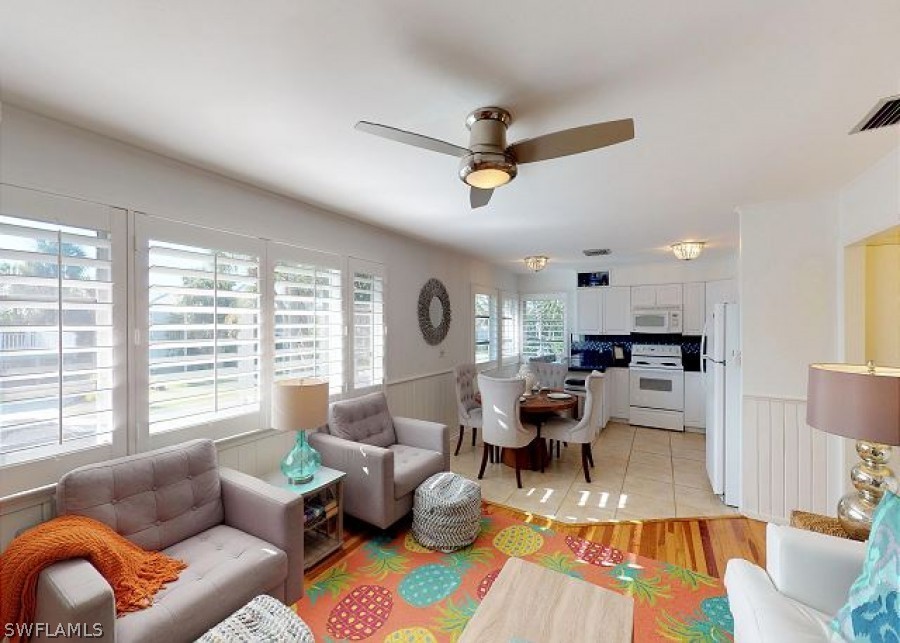 151 Mandalay Road Fort Myers Beach, FL 33931 - Photo 8 of 32 a living room with furniture and a large window