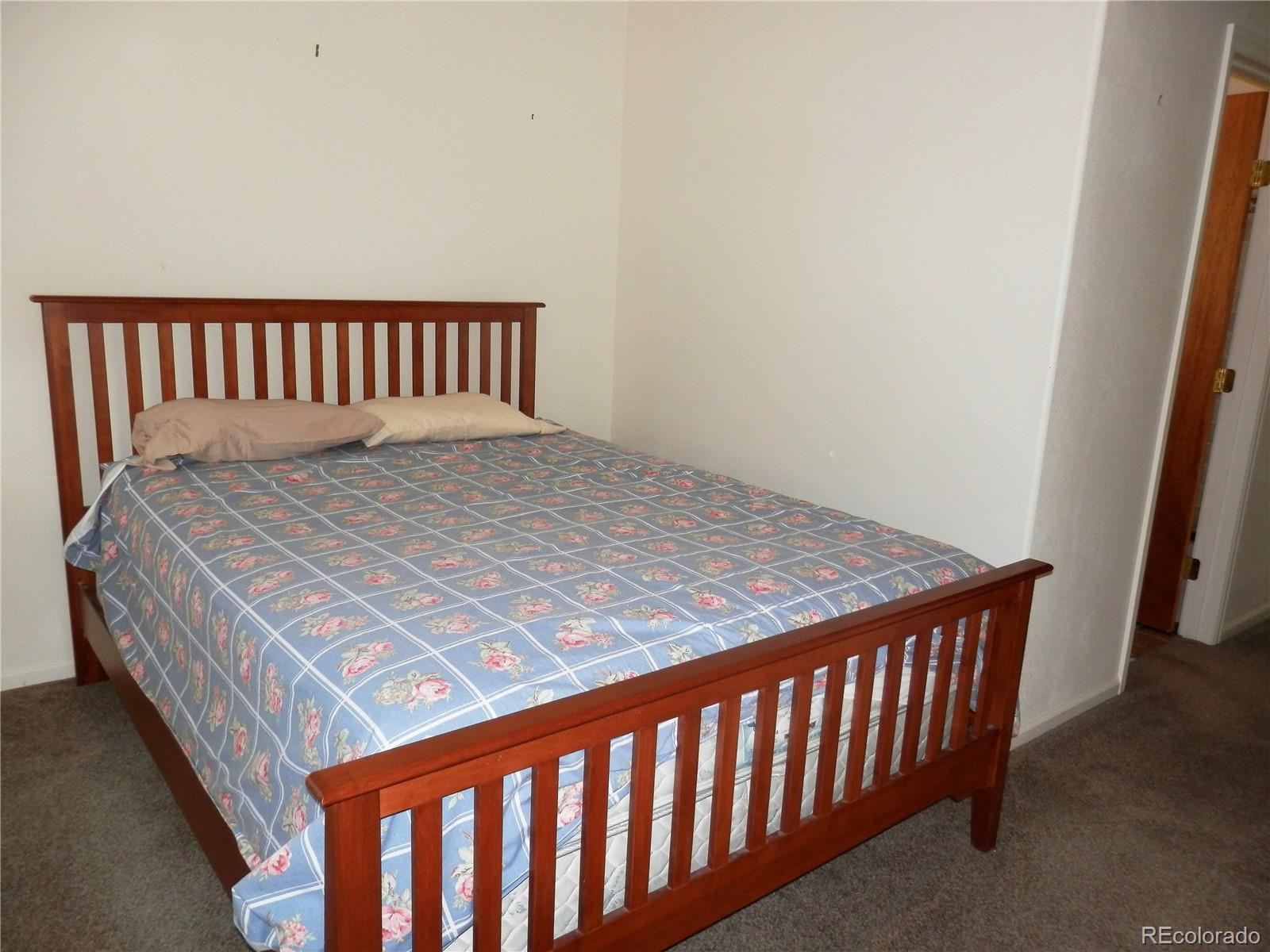 4469 Ranch Road Hartsel, CO 80449 - Photo 15 of 40 a bedroom with a bed and wooden floor