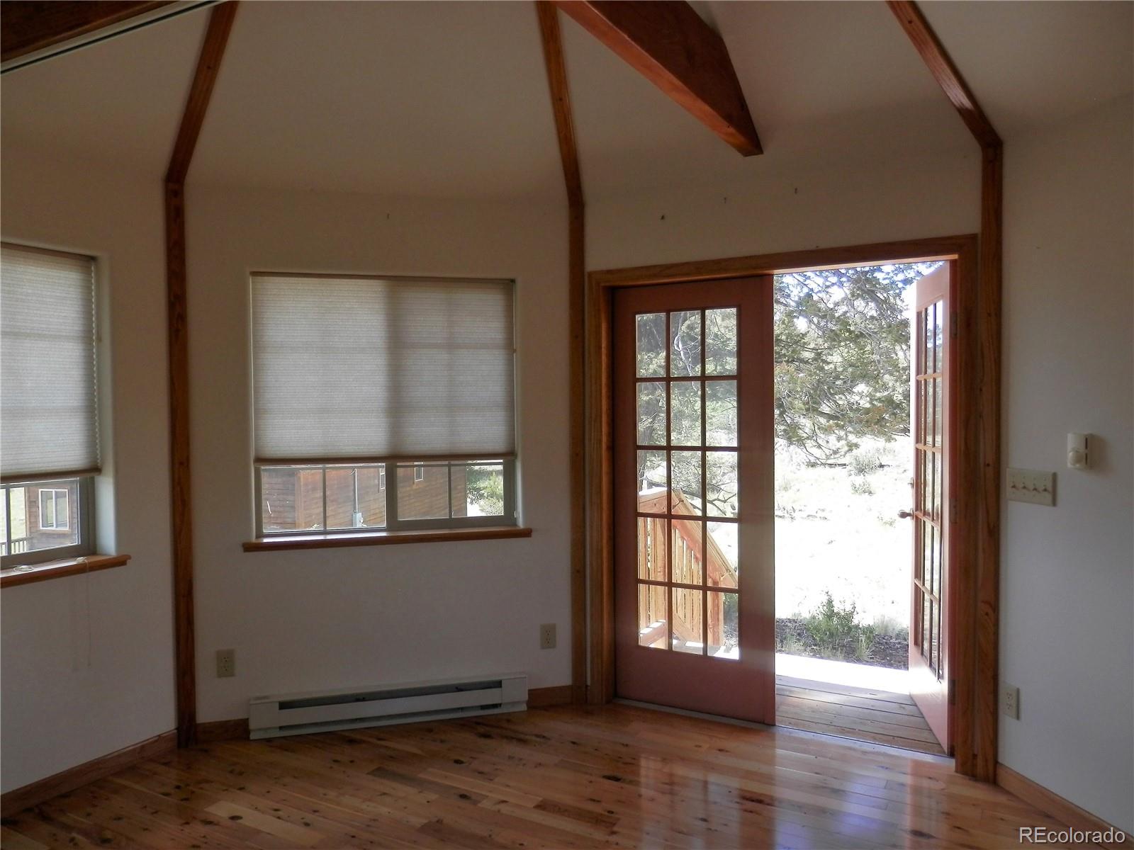 4469 Ranch Road Hartsel, CO 80449 - Photo 27 of 40 a view of an empty room with wooden floor and a window