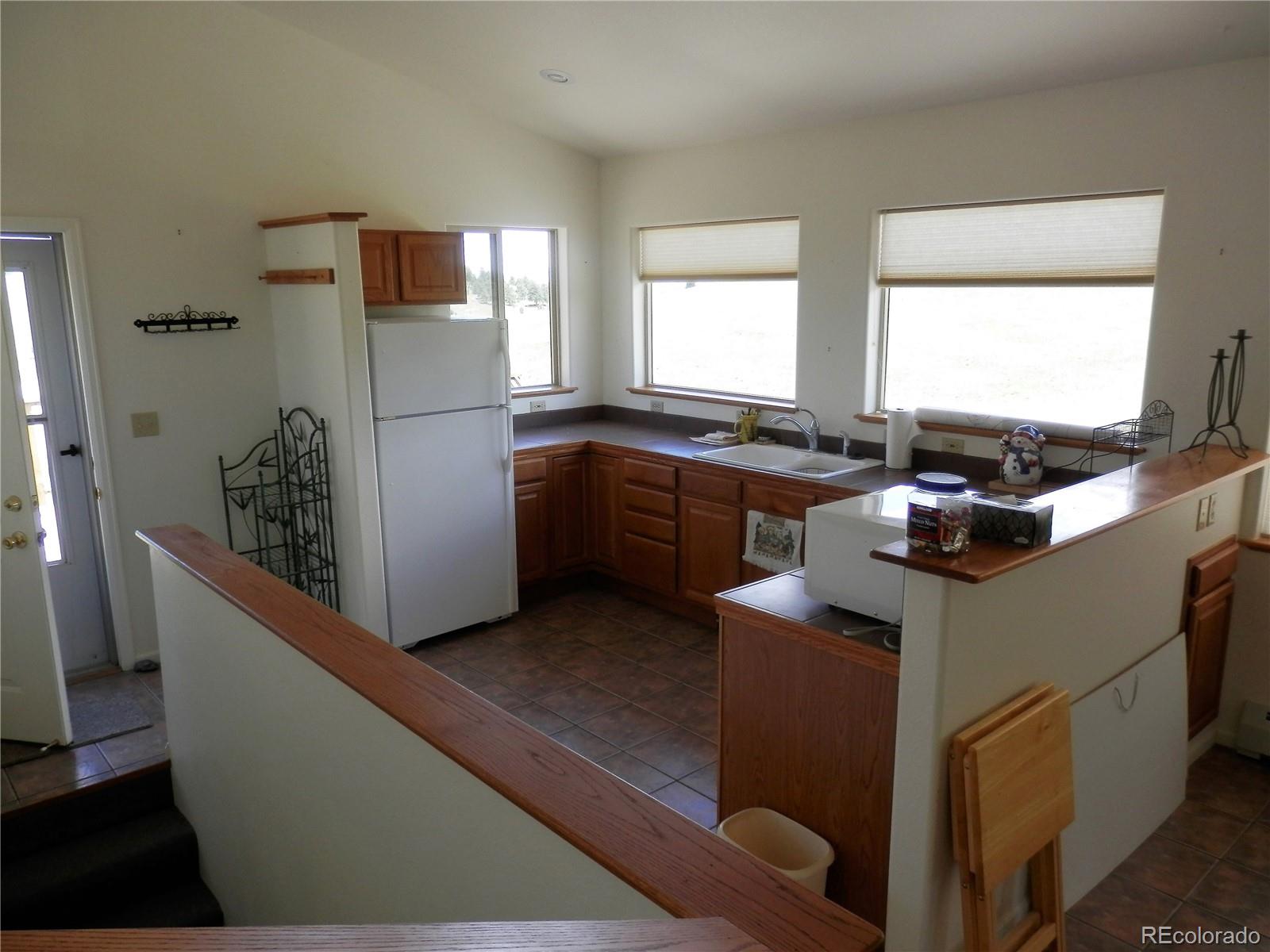 4469 Ranch Road Hartsel, CO 80449 - Photo 5 of 40 a kitchen with stainless steel appliances granite countertop a sink stove and refrigerator