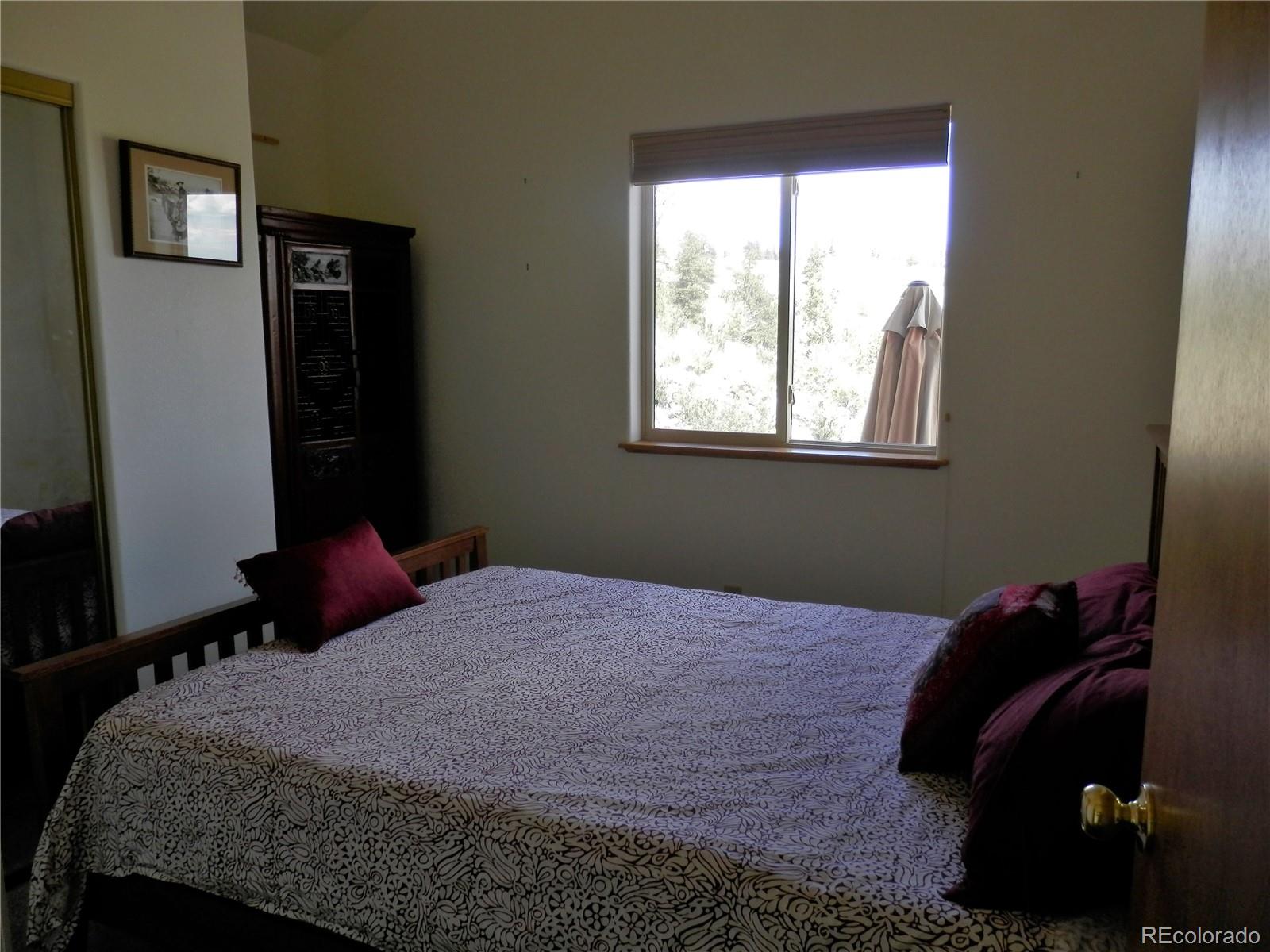 4469 Ranch Road Hartsel, CO 80449 - Photo 8 of 40 a bedroom with a bed and a window