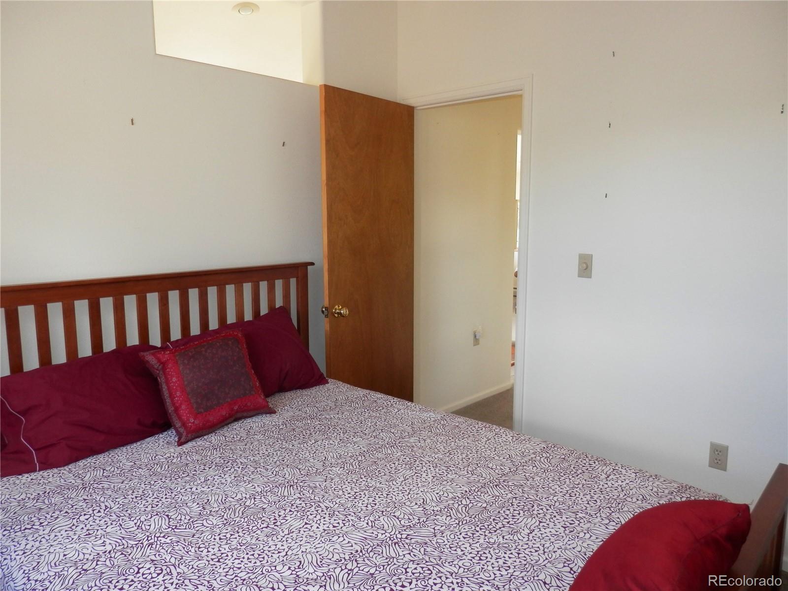 4469 Ranch Road Hartsel, CO 80449 - Photo 9 of 40 a bed sitting in a bedroom next to a window