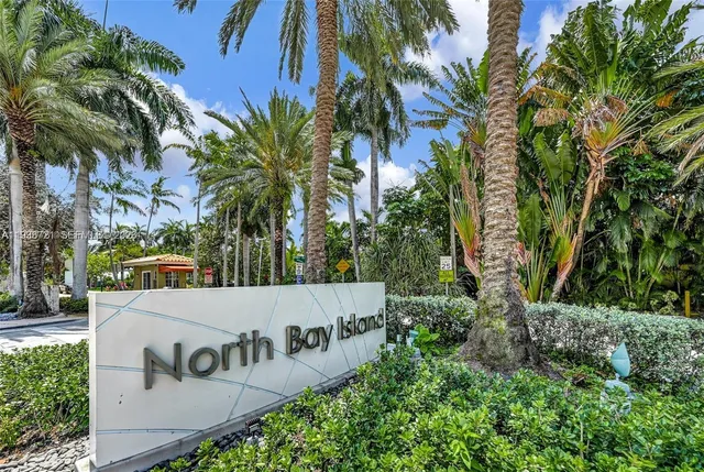 a view of outdoor space with sign board and palm trees
