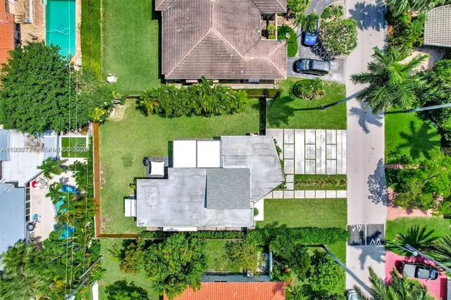 an aerial view of a house with a garden and swimming pool