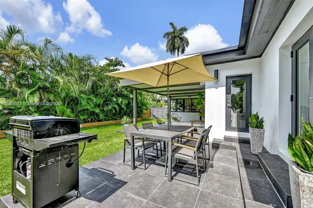a view of a patio with a table chairs and a table