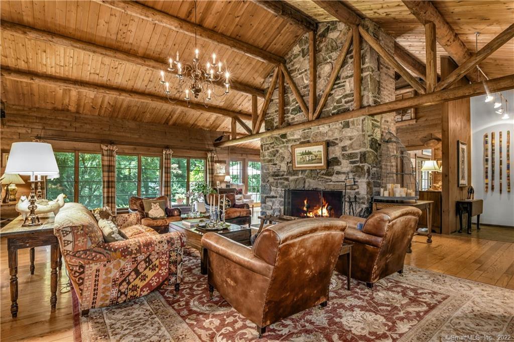a living room with furniture a fireplace and a dining table