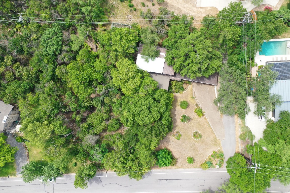 an aerial view of a house with a yard and garden