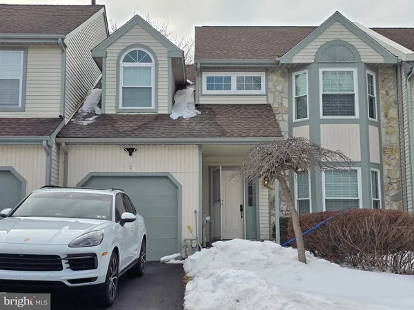a front view of a house with parking space