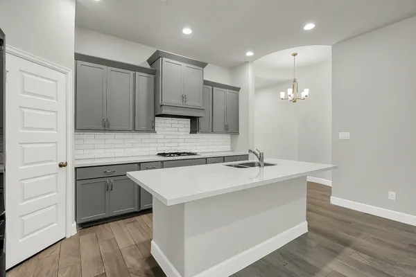 a kitchen with a sink stove and cabinets
