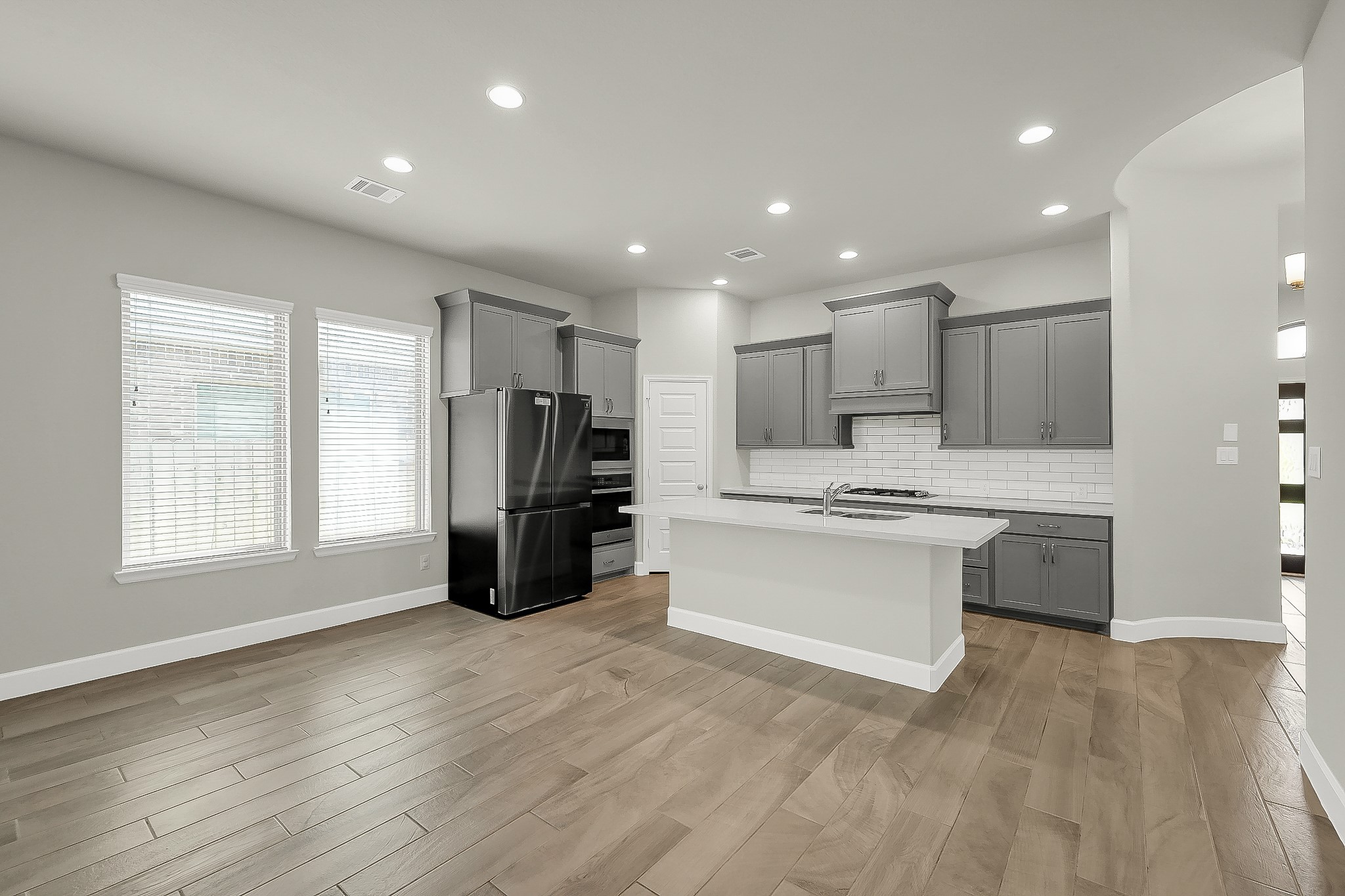 328 Rise Lane Montgomery, TX 77316 - Photo 19 of 49 a kitchen with stainless steel appliances kitchen island granite countertop a refrigerator and a stove top oven